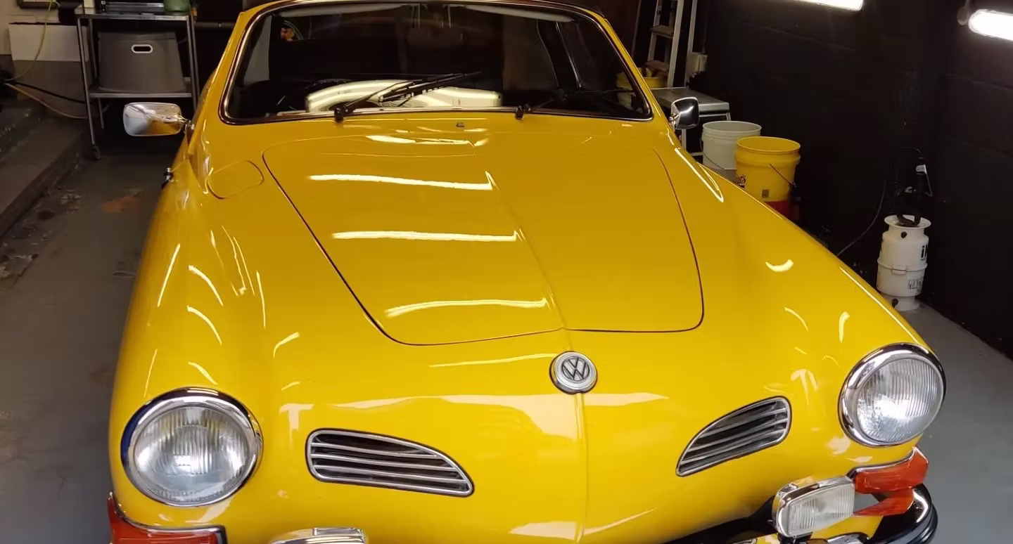 Restored yellow VW Karmann Ghia front — show polished